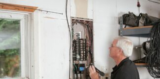 Elektryk sprawdzający domową rozdzielnicę elektryczną dla bezpieczeństwa